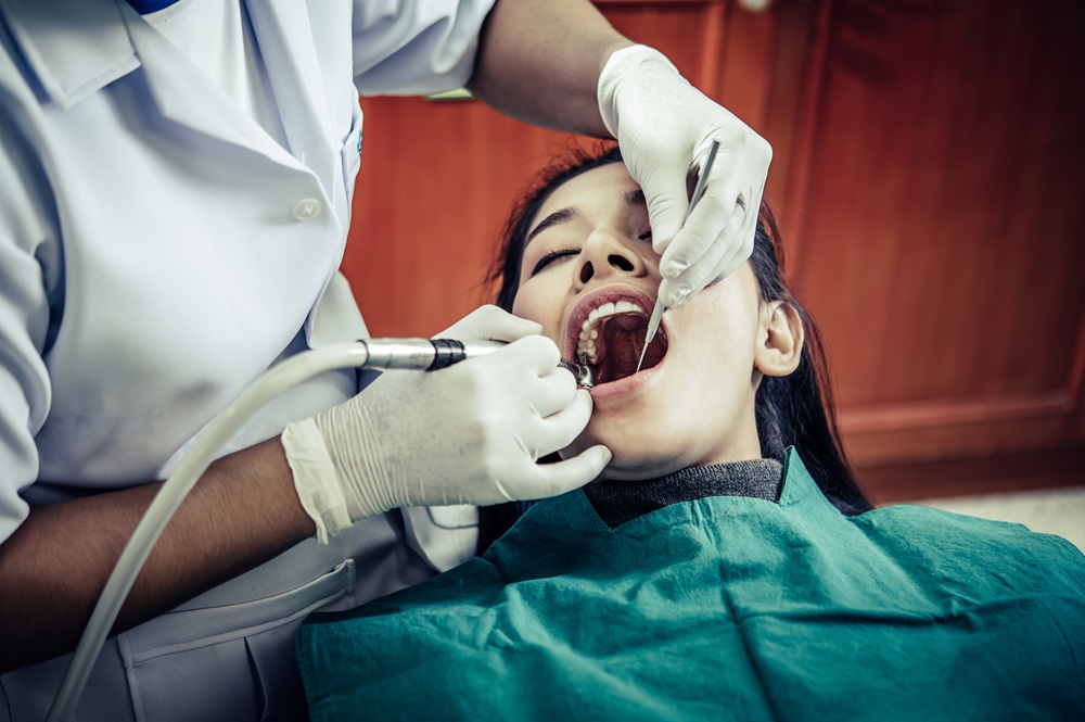 dentist performing root canal treatment